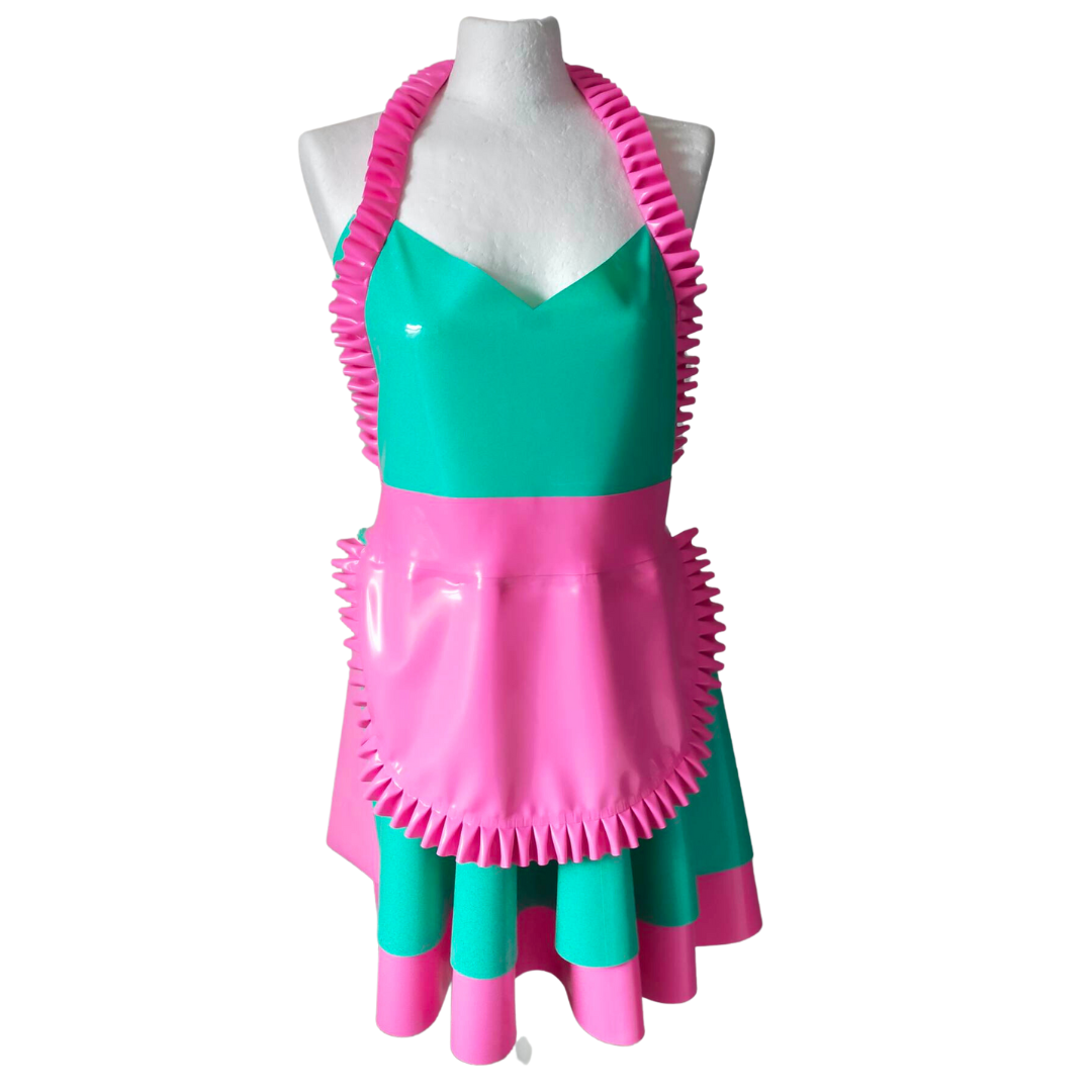 A jade green latex retro styled apron with a pink latex under skirt. The apron features pink frills around the neck and hemline.