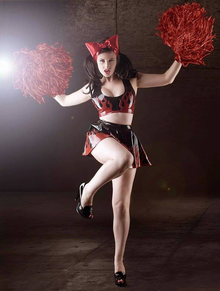 A black latex crop and skater skirt with large red flames appliques.