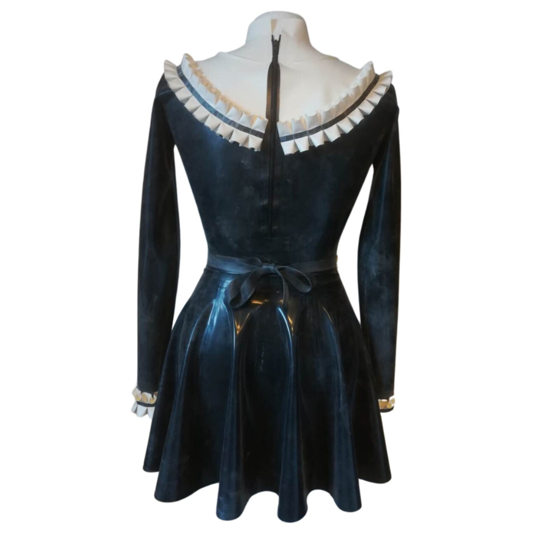 Black and white latex maid outfit on a mannequin against a white background. The collar, sleeves and apron feature double rows of frills. Shown from the back with zip opening.