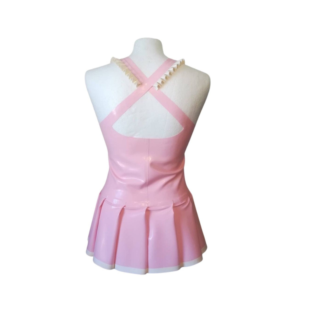 Back of a baby pink latex cheer leader dress with white frill detail