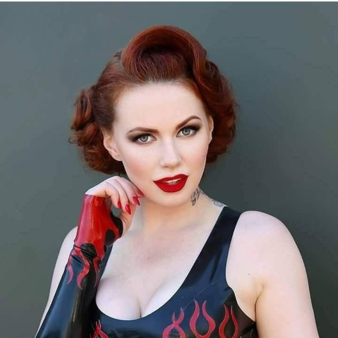 A pair of elbow length black fingerless gloves with red flames appliques.