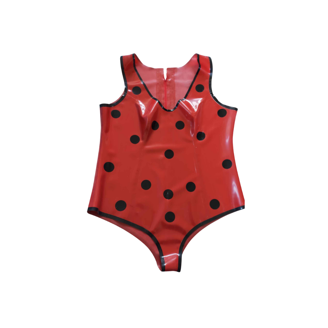 A red latex playsuit with black trim and black polka dot appliques.