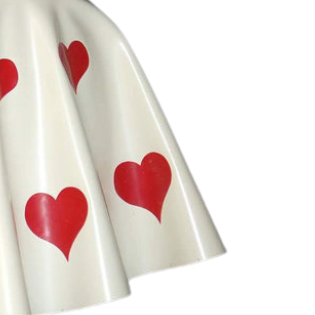 A close up of the white latex skirt with hearts appliques.