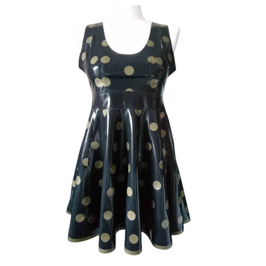 A black sleeveless fit and flare dress with gold polka dots. It has a matching gold trim on the hemline.