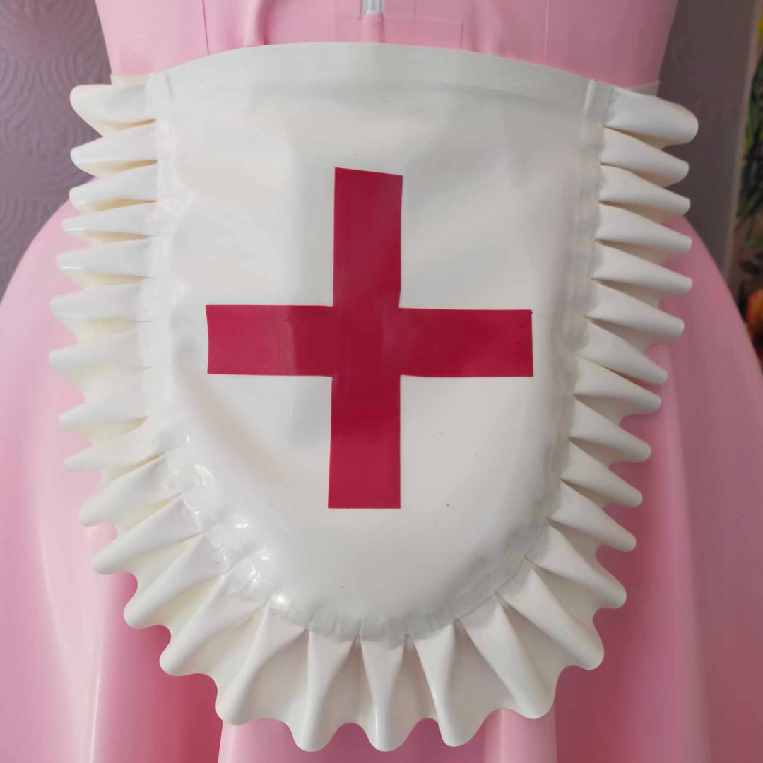 A white latex frilly nurse apron with red cross detail.
