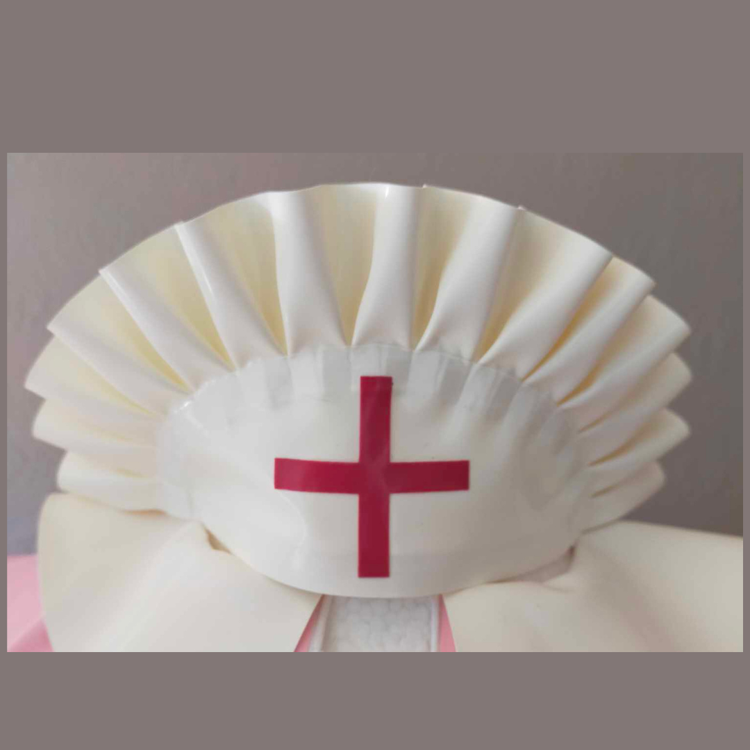A white latex frilly nurse cap with red cross detail.