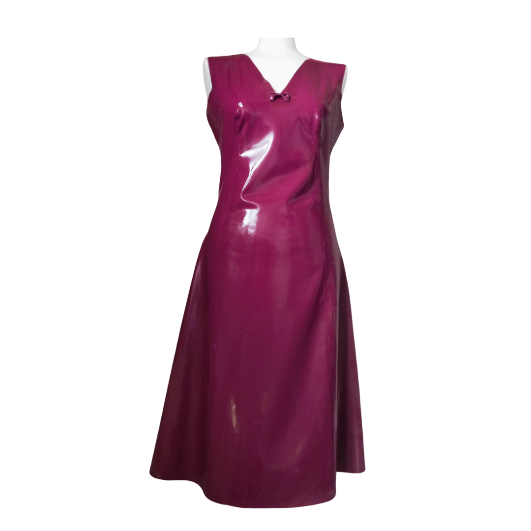 A plum latex dress with bow detail on the V neckline.