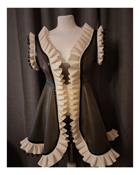 Vintage-style latex night with ruffled details on a mannequin against a dark curtain background