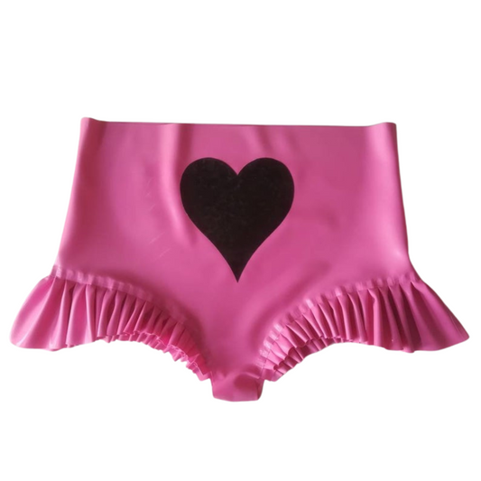 A pair of high rise latex knickers with a large black heart applique on the front. The leg line features wide frill trim.