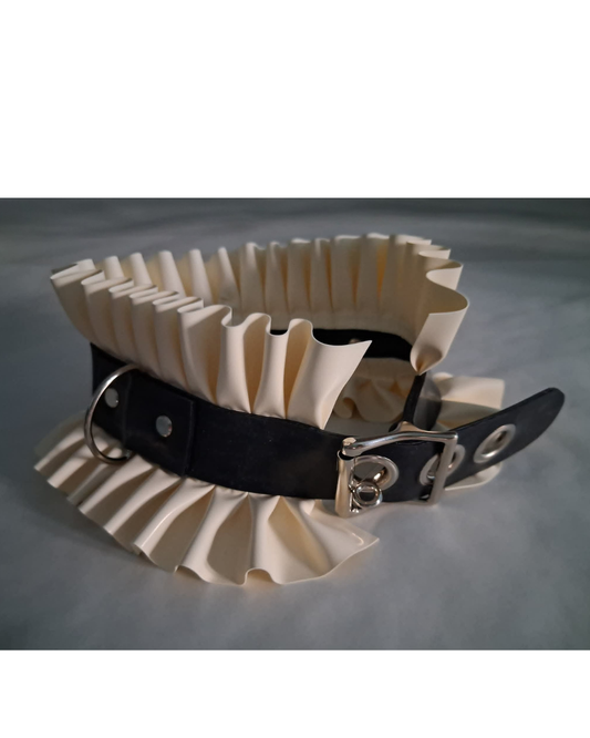 Cream-colored ruffled latex collar with black latex strap on a gray background