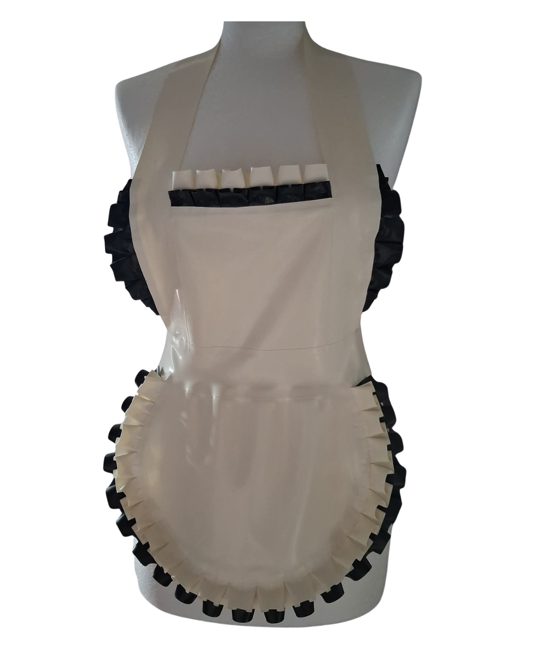 A glossy white latex apron with black double frills along the neckline, sides, and hem, displayed on a mannequin. The apron has a halter-style top and a fitted bib shape with decorative ruffled trim