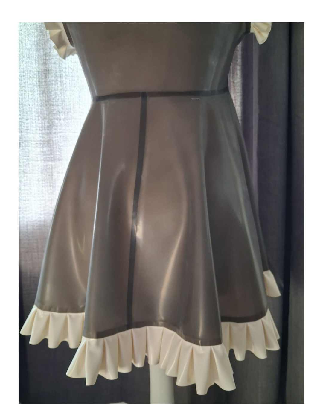 Back view of Fetasia Latex translucent black latex nightie, white frills.