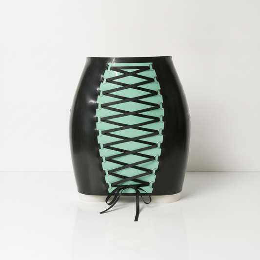 A glossy black latex skirt with a mint green front panel featuring a black crisscross lace-up design, set against a plain white background.
