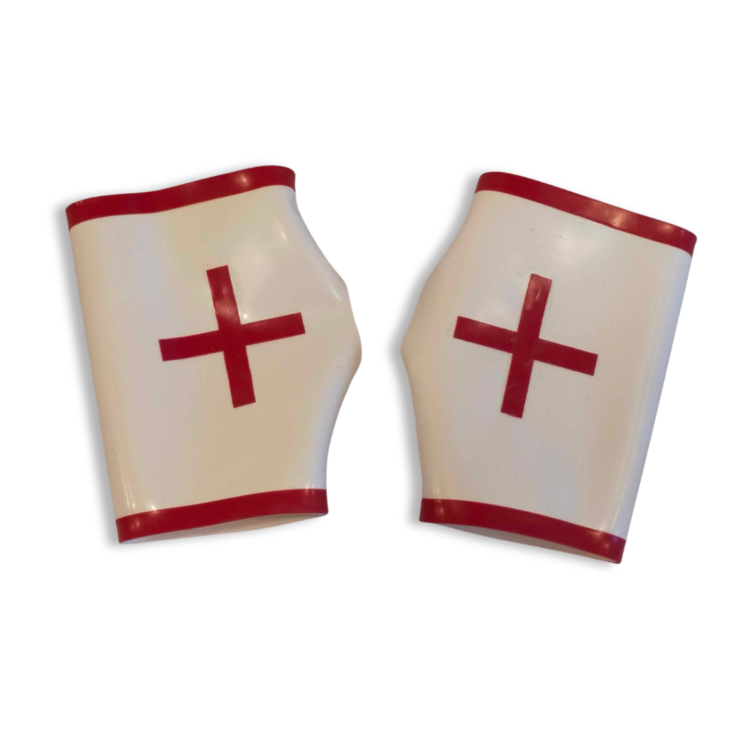 A pair of white latex fingerless latex nurse gloves with red trim and red cross appliques. 