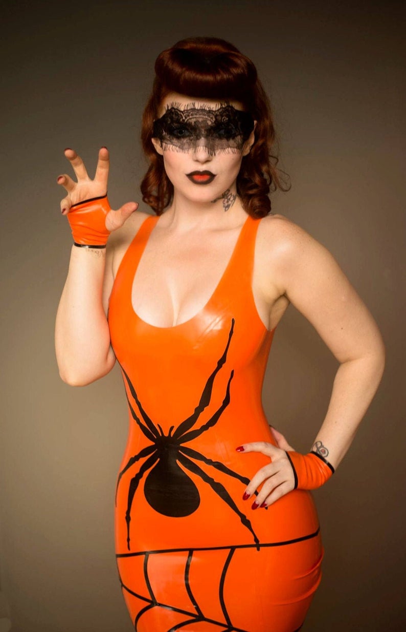 An orange latex dress with a large black spider and web applique on the front.