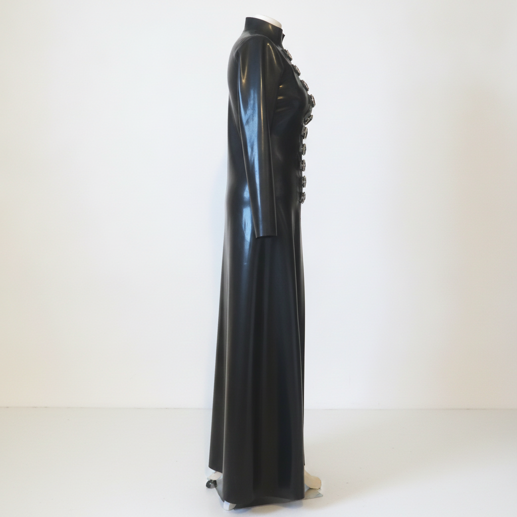 A long black latex coat with a high collar and decorative dark buttons down the front, displayed on a mannequin against a plain white studio background.
