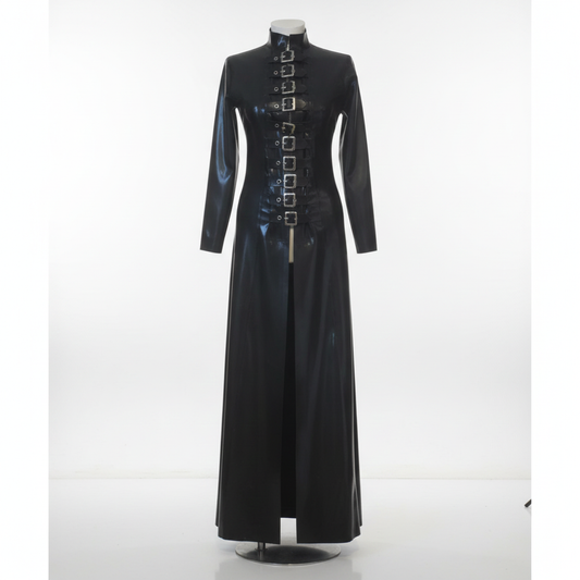 A long black latex coat displayed on a mannequin against a white studio background. The coat features a high mock neck, long sleeves, a front slit, and a vertical row of silver rectangular buckle details down the centre front.