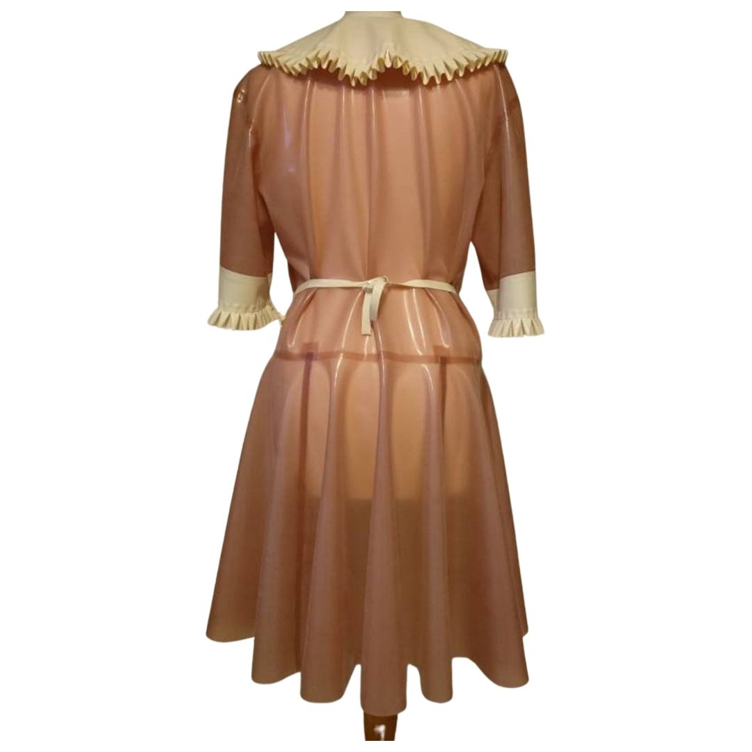 A translucent pink French maid outfit, comprising of dress and apron.
The white latex apron , cuffs and collar feature delicate frills.