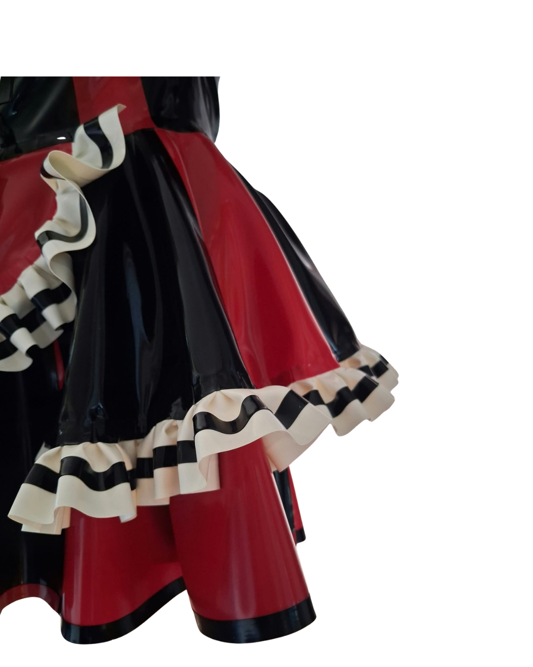 Close-up of a glossy black and red skirt with layered cream ruffles, shown against a plain white background.