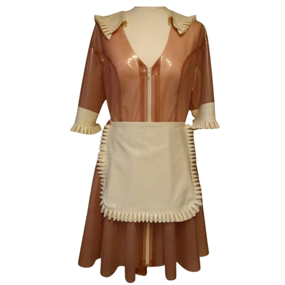 A translucent pink French maid outfit, comprising of dress and apron.
The white latex apron , cuffs and collar feature delicate frills.