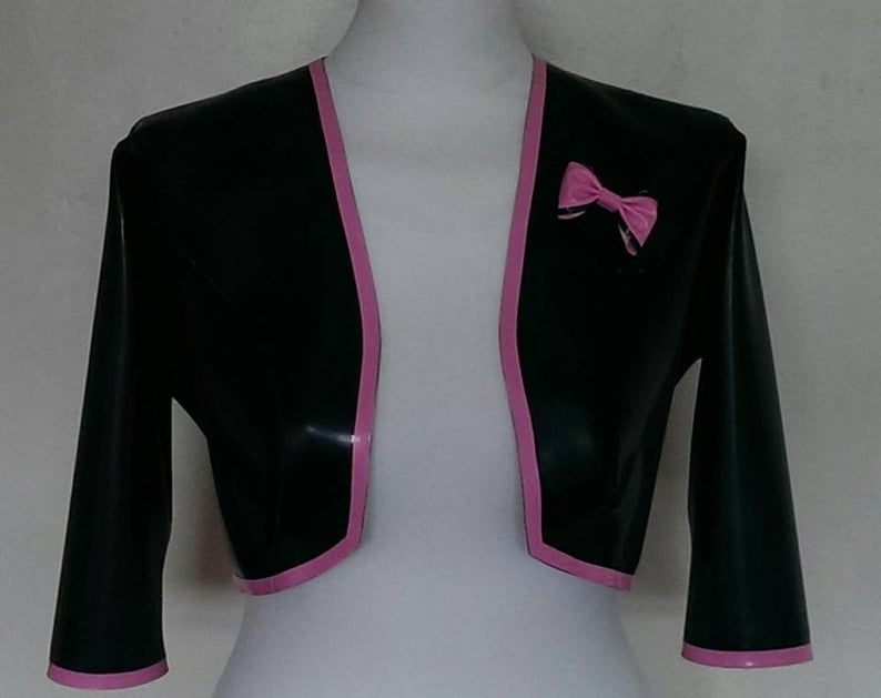 A lack latex bolero jacket with pink trim and bow detail