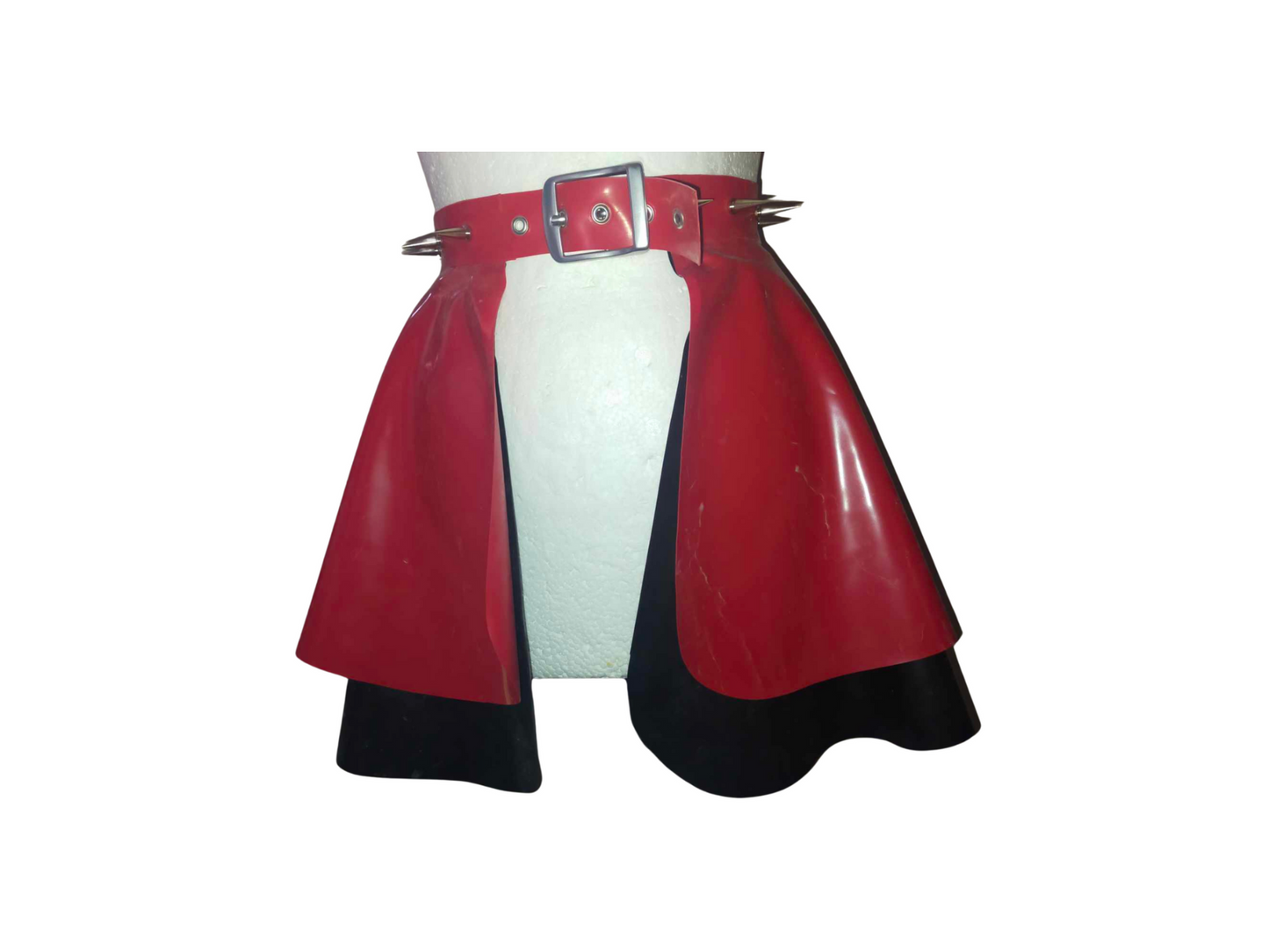 a red latex peplum skirt with black under layer. The attached belt is adorned with large silver coloured spike studs.